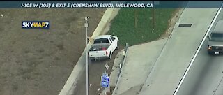 White pickup truck driving on shoulder in CA