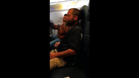 Sleepy Guy Forgets He Is On An Airplane And Lights A Cigarette