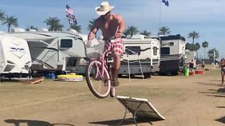 Festivalgoer jumps and breaks bicycle