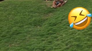 Two Tot Boys Try To Sled Down A Hill Off Grass