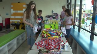 Families work together to bring school supplies to teachers