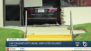 Car slams into bank, hitting employee