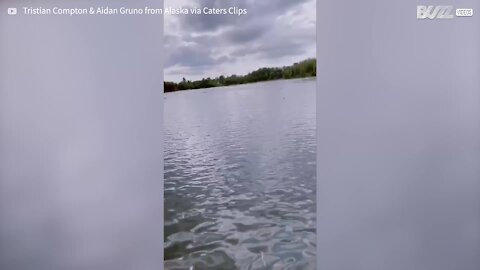 Young man falls into lake and catches fish with bare hands