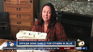 Officer sews shield for others in blue