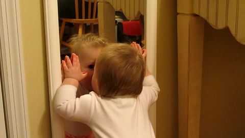 "Cute Little Girl Gives Herself Kisses In Mirror"