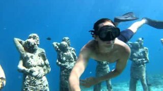 Tourists swim to underwater statues in Bali