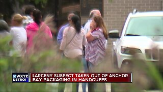 Larceny suspect taken out of Anchor Bay Packaging in handcuffs