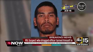 Suspect who dragged officer turns himself in