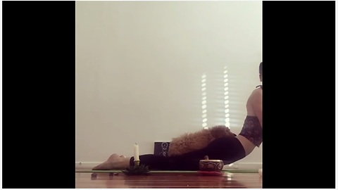 Puppy decides to nap on owner during yoga instruction