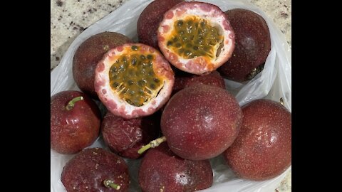 Turning some passion fruit into a refreshing juice