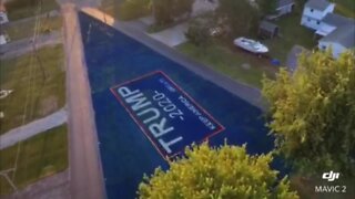 Man paints lawn with Trump sign