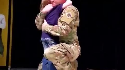 School Stage Becomes A Place Where Sergeant And Daughter Share A Hug