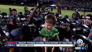 9-year-old Mason Thomas scores touchdown at halftime