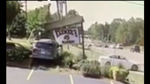 Cars Drives Through Sign And Into Traffic Trying To Park