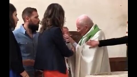 Appalling footage shows a priest violently slapping a crying baby during baptism.
