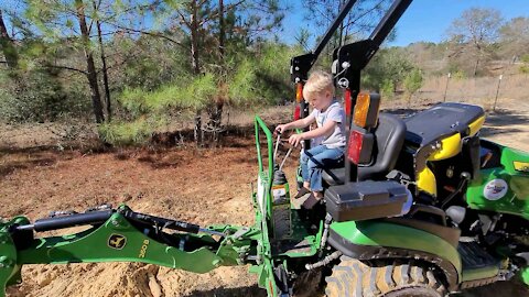 Youngest using a backhoe