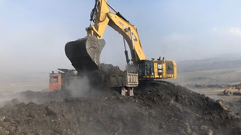 Caterpillar 6015B Excavator Loading Mercedes And MAN Trucks With One Pass