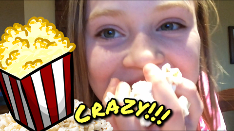 Little girl stuffs her face with popcorn!