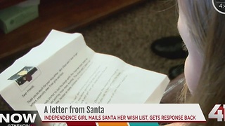 Little girl receives letter from Santa before Christmas