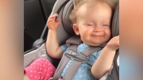 A Baby Girl Laughs As The Wind Blows Back Her Hair