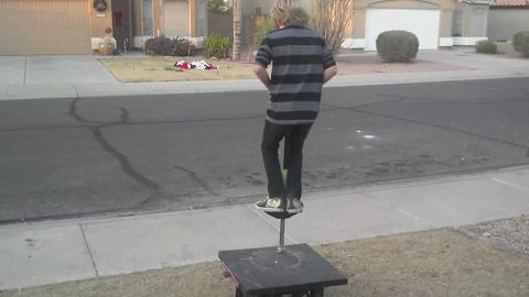 Young Boy Tries To Do A Trick On A Pogo Stick But Fails