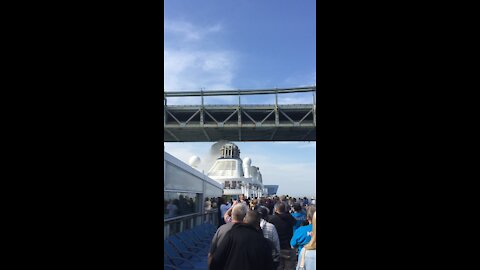 Cruise ship passing under bridge.