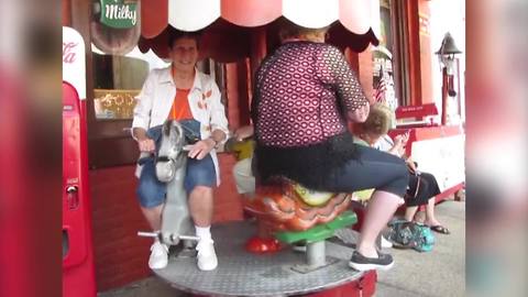 Three Senior Ladies Have A Blast On A Merry Go Round