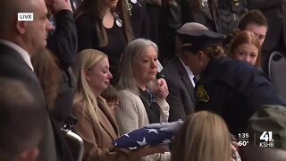 KCPD Officer James Muhlbauer's wife, son presented with flag during funeral ceremony