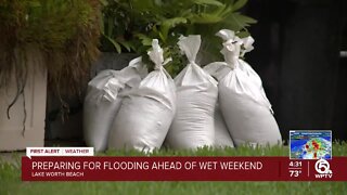 Neighbors stack sandbags, clear storm drains in Lake Worth Beach