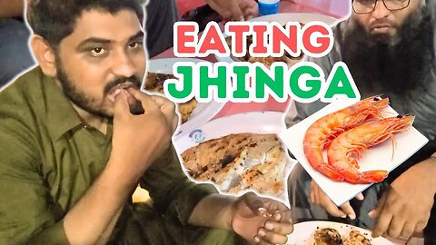 EATING PRAWN AT KEMARI SEA FOOD MARKET IN KARACHI PAKISTAN