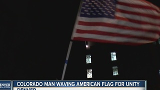 Colorado man waving American flag for unity