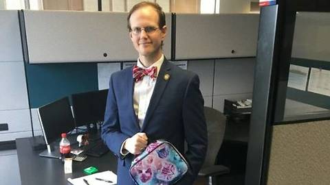 American man takes kitty lunchbox to work to support young cousin