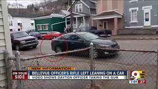 Officer's rifle left leaning on a car