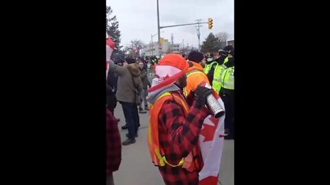 CANADIANS SING ANTHEM IN FRONT OF POLICE