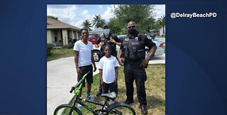 Officers give 15 students new bicycles
