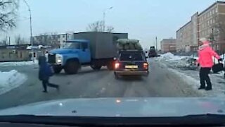 Child crosses street unexpectedly, almost gets hit by truck