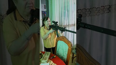 Mom holding a Tokyo Marui MP5A5 SRE NEXT Gen Airsoft 😁