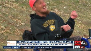 Community gifts man with specialized chair