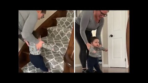 Mommy helps excited baby go up the staircase