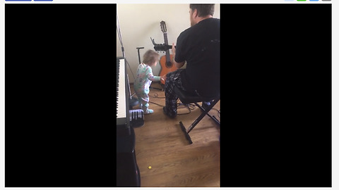 Baby girl rocks out to dad's guitar performance
