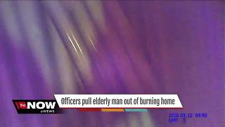 Officers pull elderly man out of burning home