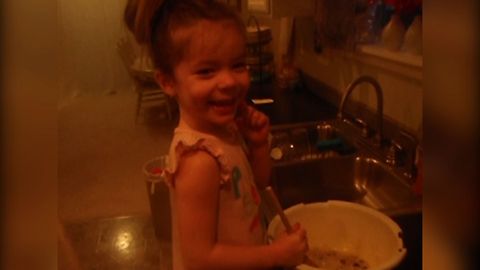Little Girl Adds A Special Ingredient Into Muffins