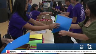 Volunteers stuff backpacks for North County students in need