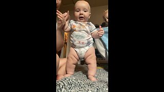 First time standing up, big sister makes her little brother laugh