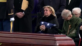 Rep. Debbie Dingell receives the flag from her late husband, John Dingell's casket