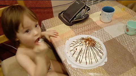 Funny baby eats a whole cake.