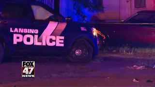 Officer hurt in Lansing crash