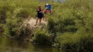 A Woman Tries To Jump Off Dirt Cliff Into Water