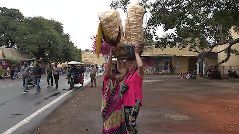 Kindly vendor in India trusts Canadian tourist to carry her papadums