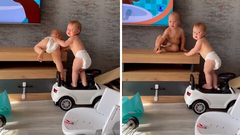 Baby Adorably Helps Twin Sibling Climb Onto Furniture